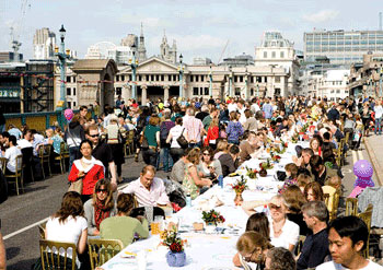 Here are people sitting down and starting to eat. Here are people sitting down and starting to eat.